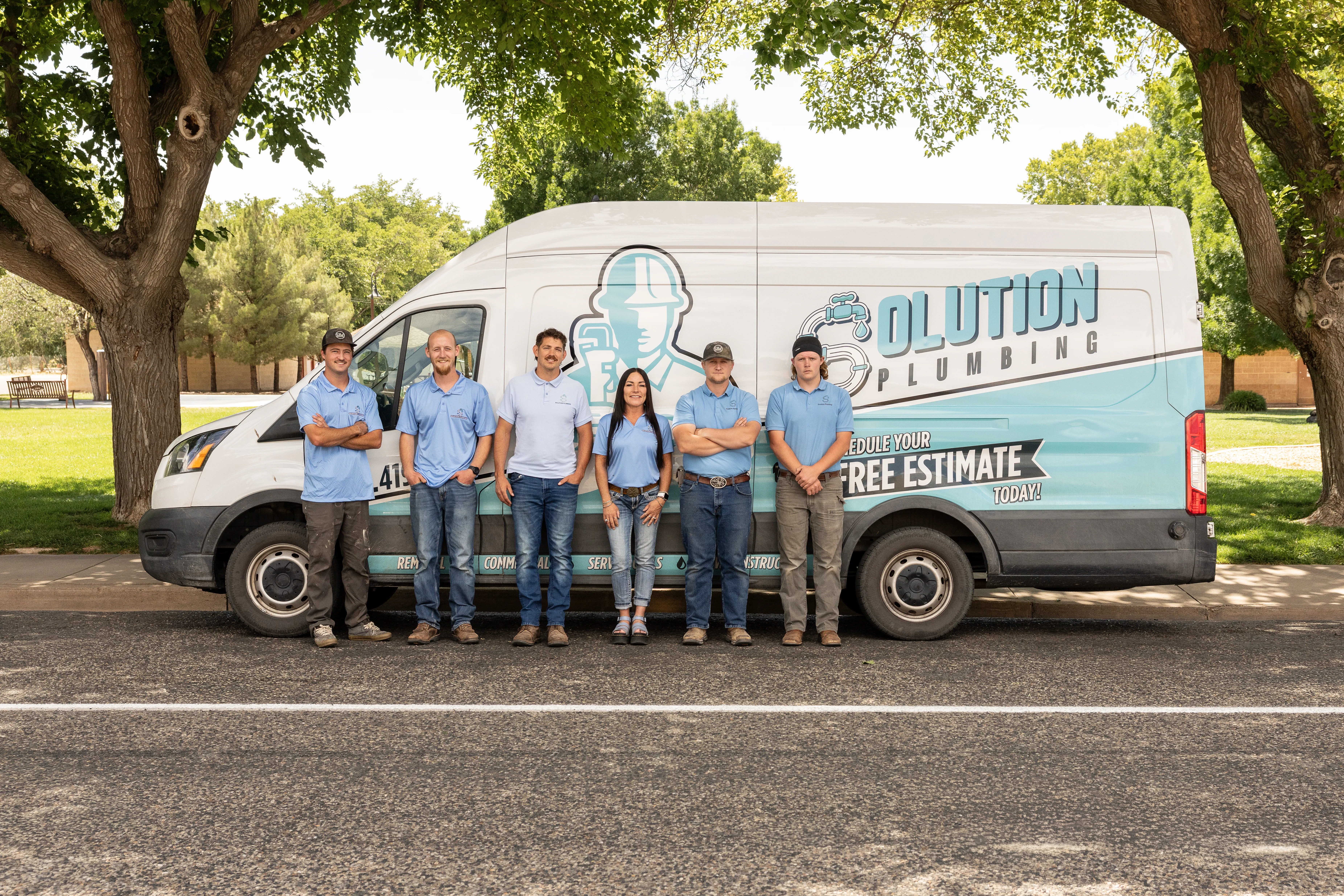 The Solution Plumbing crew in front of a company van