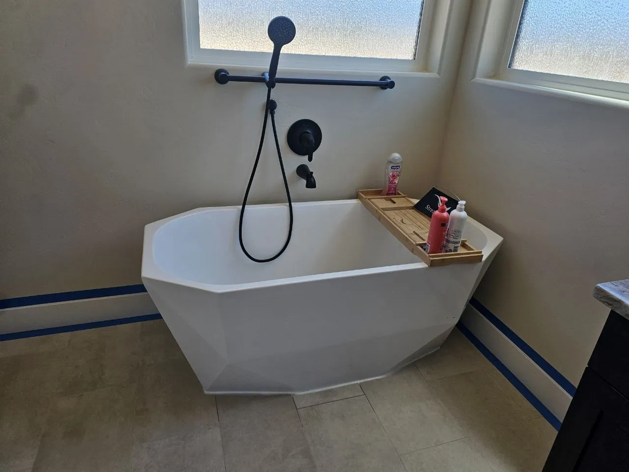 A finished freestanding-tub bathroom by Solution Plumbing